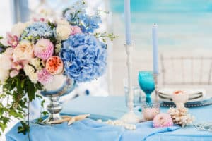 Floral arrangement for bride and groom table with blue and pink flowers