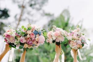 Bridesmaids holding colorful bouquets during wedding