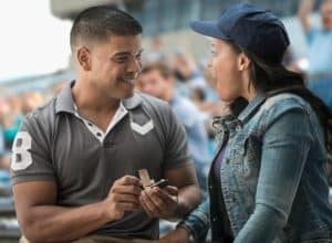 Man proposing to girlfriend at baseball game