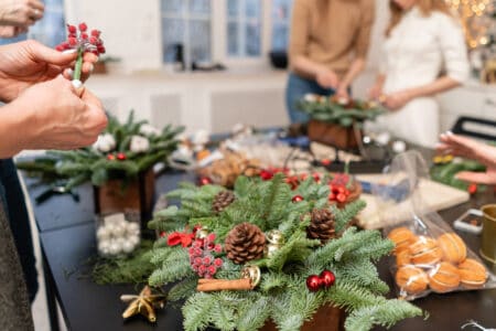 Master class on making decorative ornaments. Flower shop. Christmas decor with their own hands. Woman created a xmas arrangement.