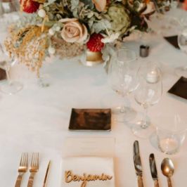 Wild & Free Photography Gold and white table setting with wedding florals.